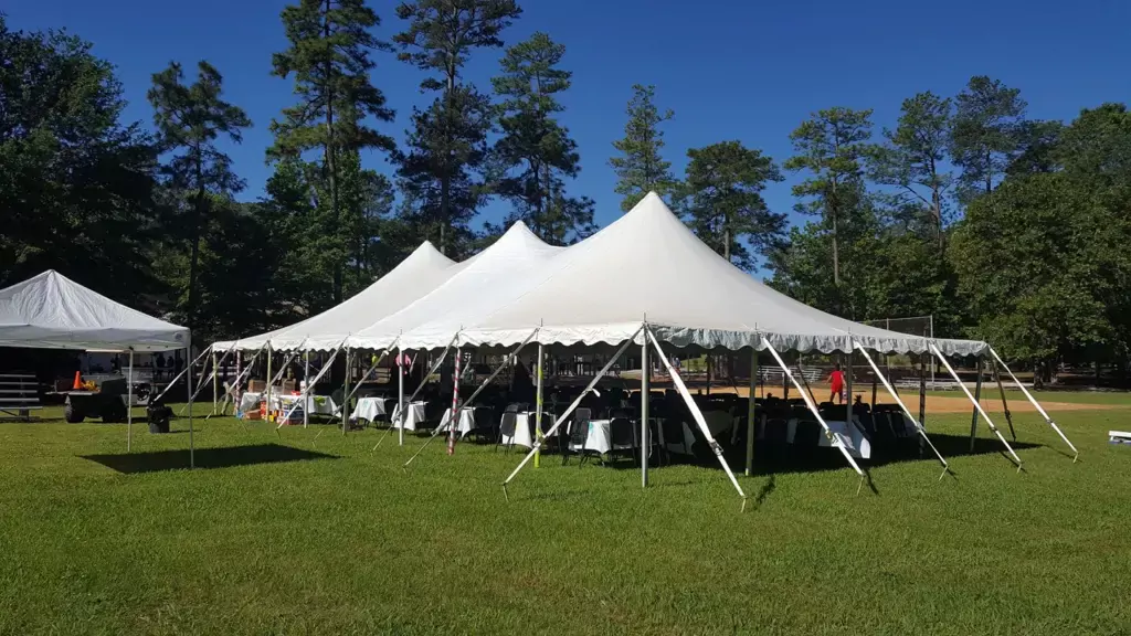 A company picnic under beautiful white tents