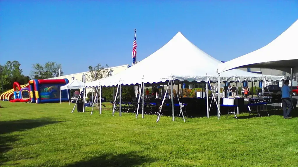 Beautiful white 30 by 30 foot tents at a company picnic