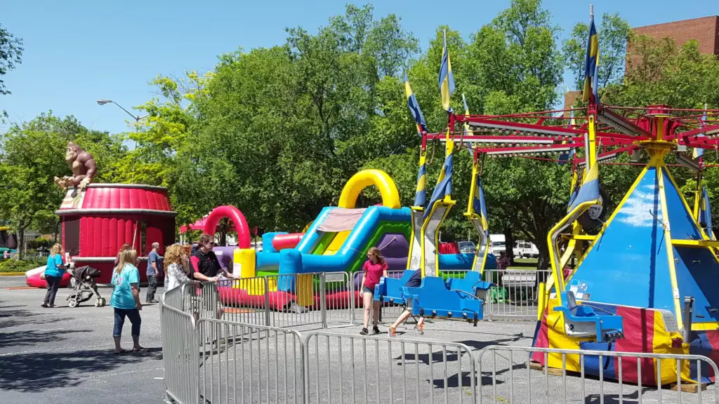 A community festival with rides and inflatables